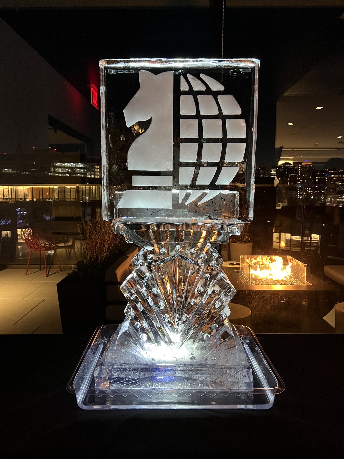 An ice sculpture depicting the logo of Harvard Undergraduate Foreign Policy Initiative sits on a table at a club formal in April 2022.