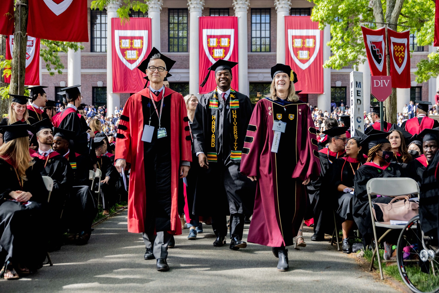 Dean of Arts and Humanities Robin Kelsey, former Undergraduate Council President Noah A. Harris '22, and Dean of Students Katherine G. O'Dair walk down the aisle in Thursday's Commencement Exercises.