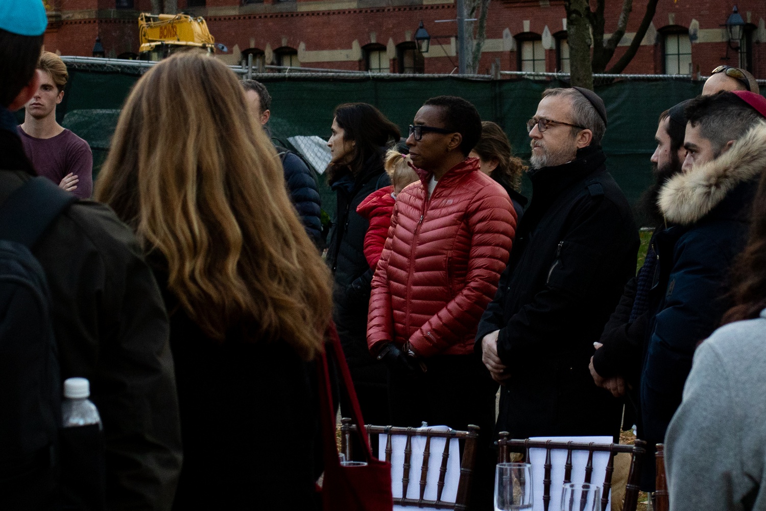 Gay, standing next to Harvard Chabad President Rabbi Hirschy Zarchi, views an Shabbat table installation in the Yard symbolizing the hundreds of hostages held by Hamas.